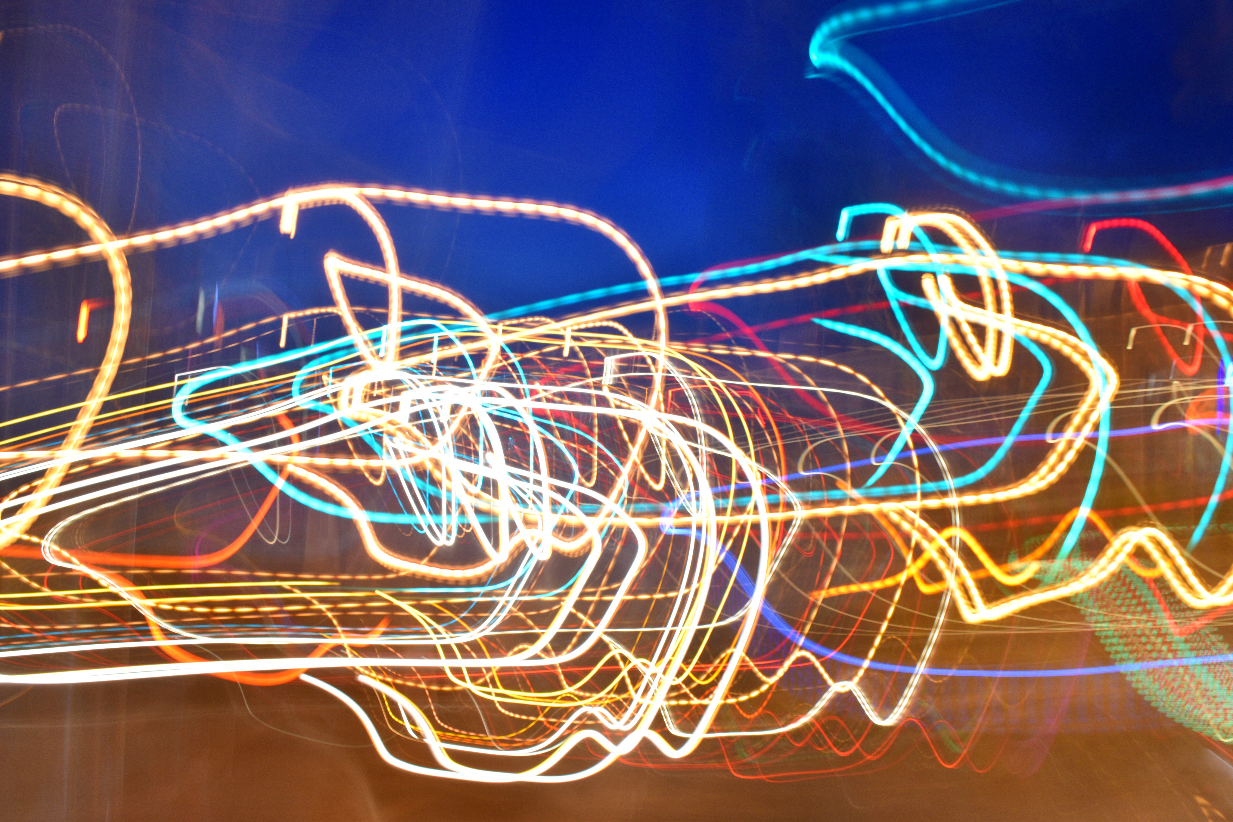 An abstract image taken with a long exposure that looks like many multicolored lights intersecting